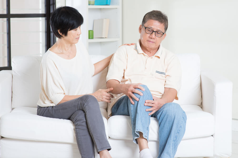 Can physical therapy exercises help reduce fluid in the knee? shutterstock 300181310 stiff knee after sitting