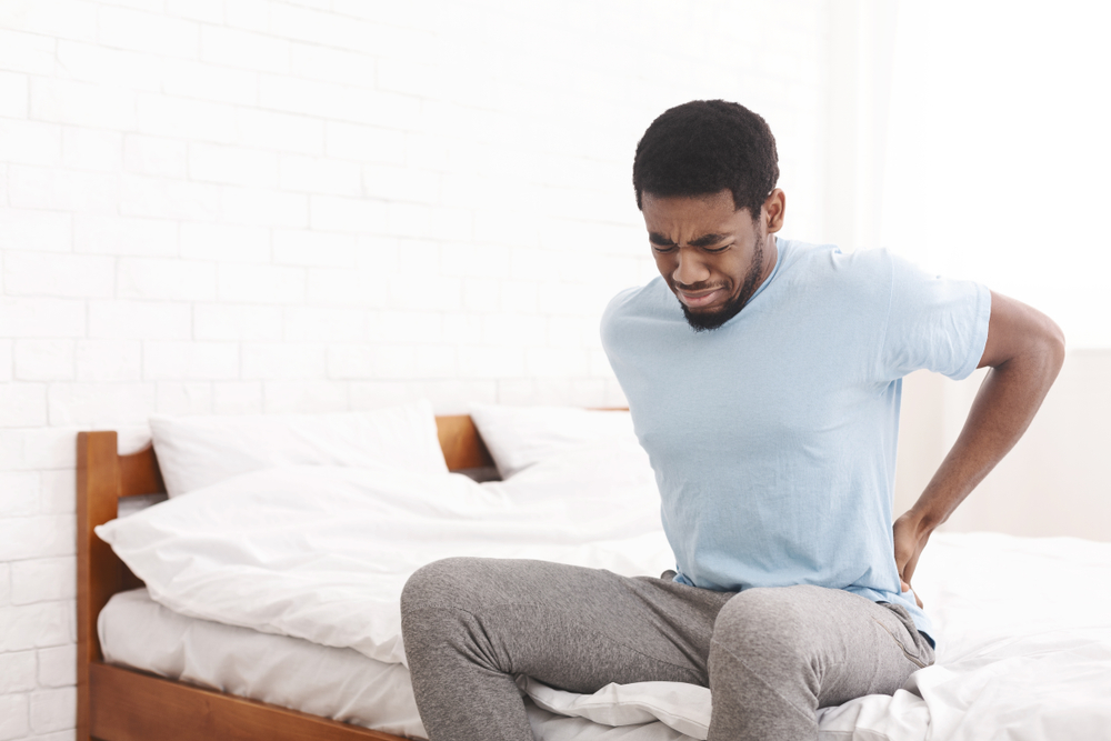 3 possible reasons why my back hurts when I lay down shutterstock 1329349922 back hurts when i lay down