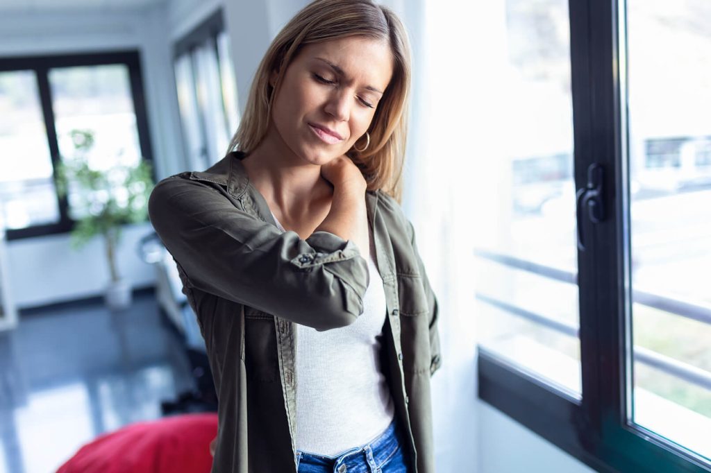 3 ways to treat scoliosis-related neck pain with physical therapy tired young woman with neck and back pain standing 2022 12 15 18 11 30 utc scoliosis